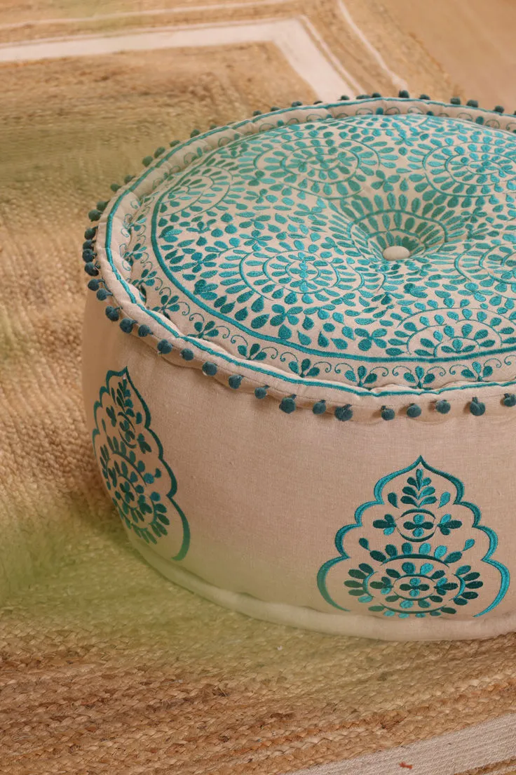 Teal Embroidered Round Pouf on Jute Rug